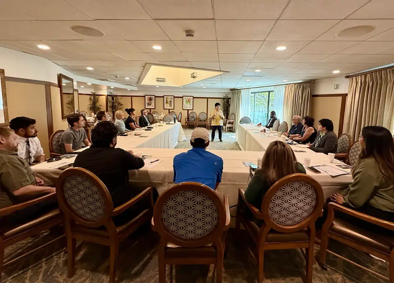 A speaker addressing seated attendees at a Pasadena Leads Group meeting