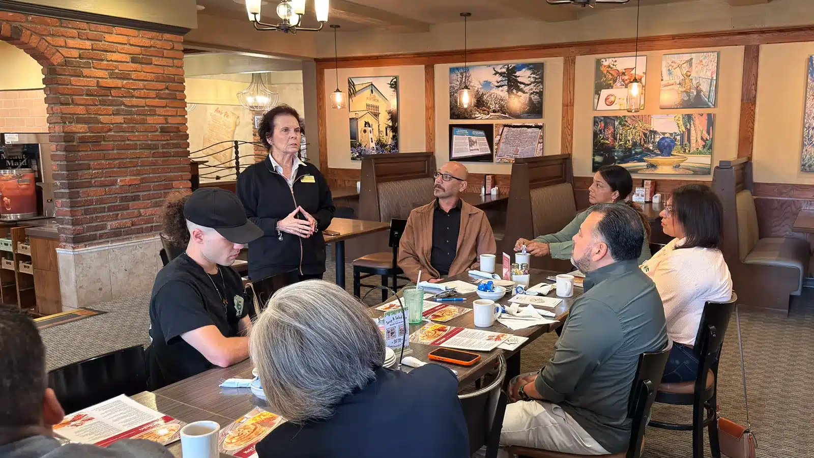 Attendees listening around tables at an Azusa Leads Group meeting